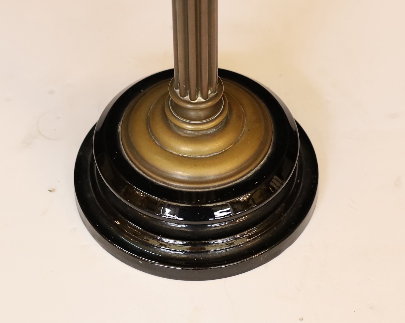 An Edwardian brass oil lamp with cut glass reservoir and pink tinted etched glass globe and flue, height overall 65cm